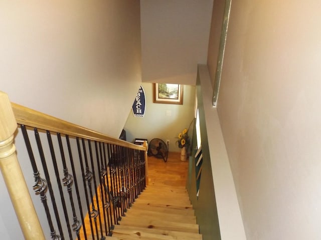 stairs with a skylight and wood finished floors