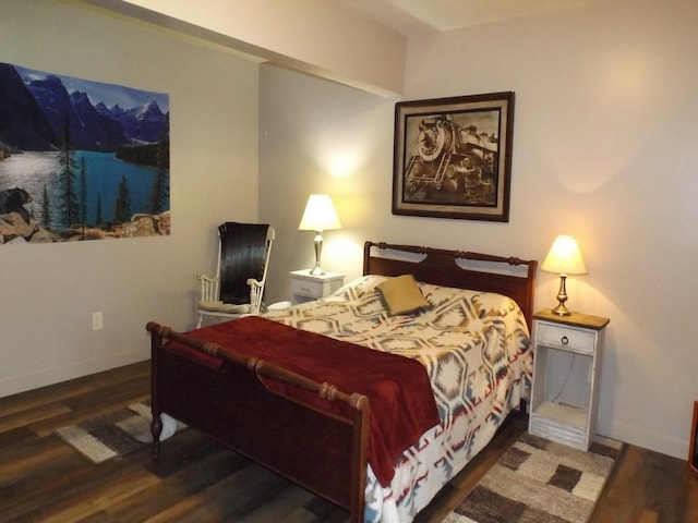 bedroom with baseboards and wood finished floors