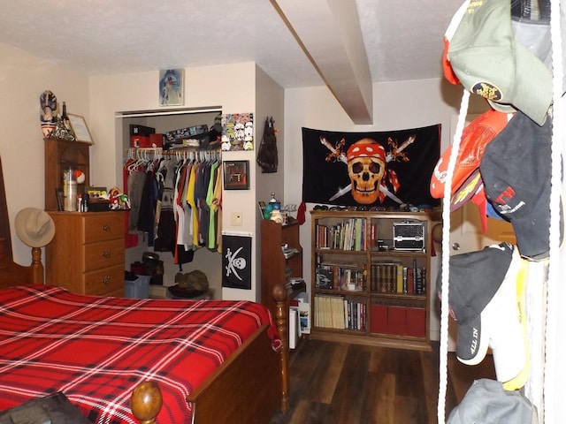 bedroom featuring wood finished floors and a closet