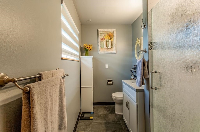 bathroom with vanity, toilet, and walk in shower