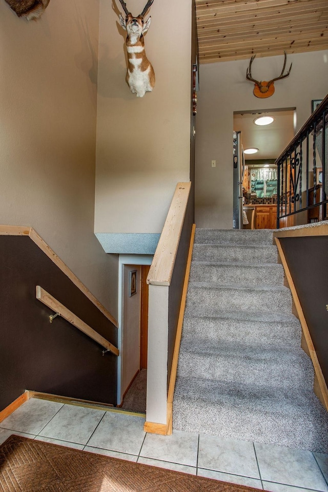 stairs featuring wooden ceiling and tile patterned flooring