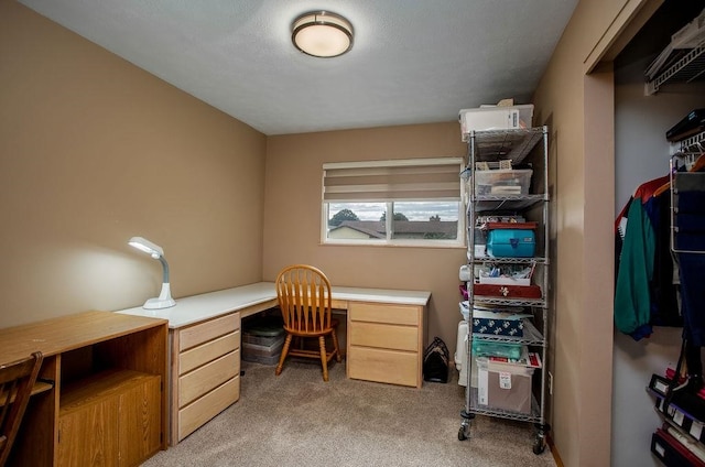 home office featuring light carpet and built in desk