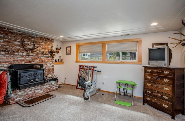 living area with a fireplace and carpet