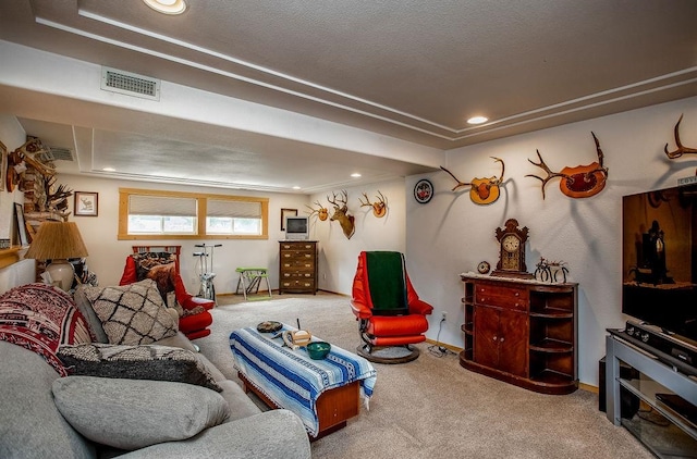 living room featuring a textured ceiling, carpet, and ornamental molding