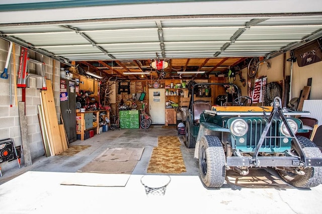 garage with a garage door opener and a workshop area