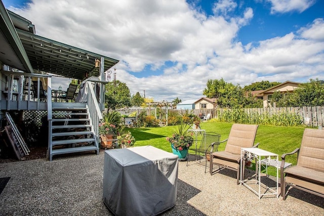 view of patio / terrace with a deck, stairway, and fence