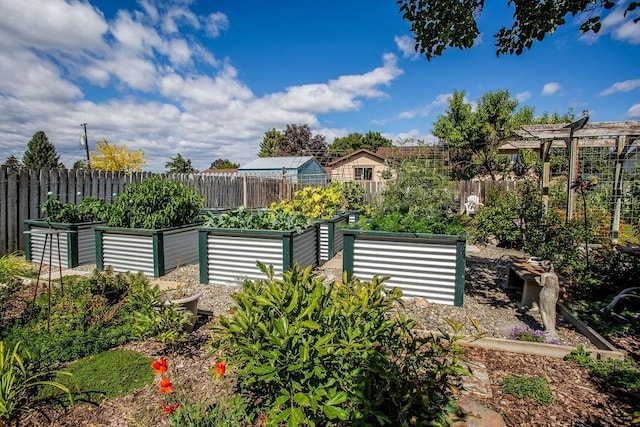 view of yard featuring a vegetable garden and fence