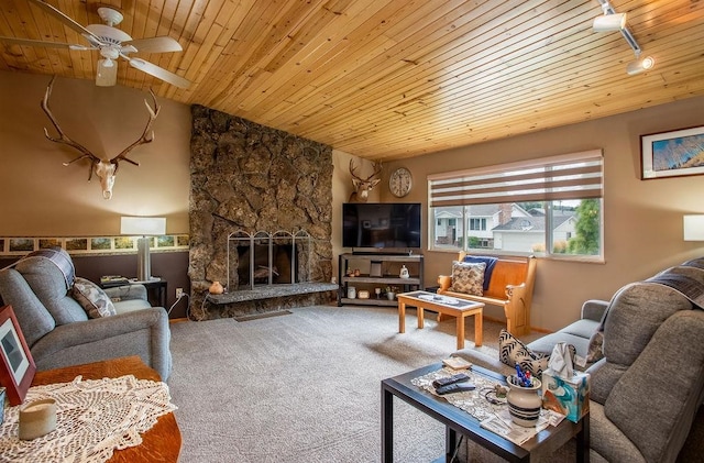 carpeted living room with a stone fireplace, ceiling fan, lofted ceiling, and wooden ceiling