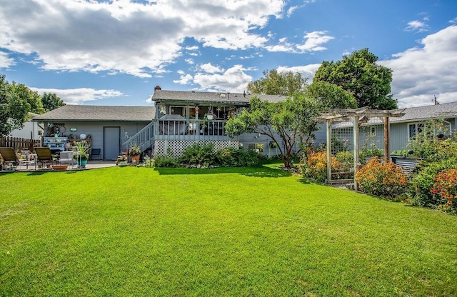 rear view of property with stairs, a pergola, a lawn, and a patio