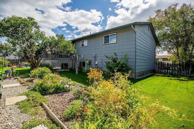 back of property featuring cooling unit and a yard