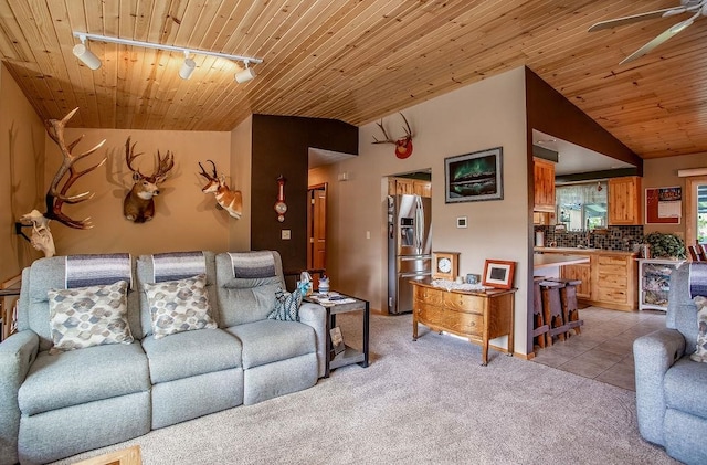 living room featuring track lighting, light colored carpet, and wood ceiling