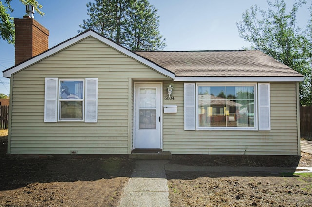 bungalow-style house with roof with shingles