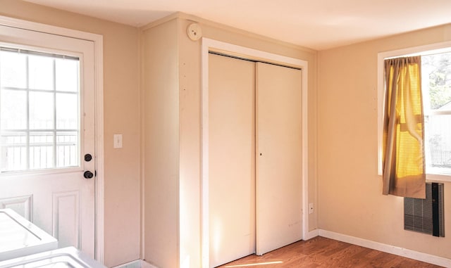 entryway with plenty of natural light, baseboards, and wood finished floors
