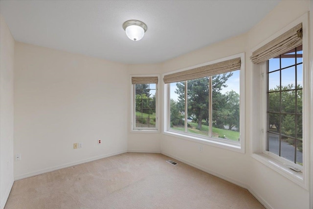 empty room featuring light colored carpet