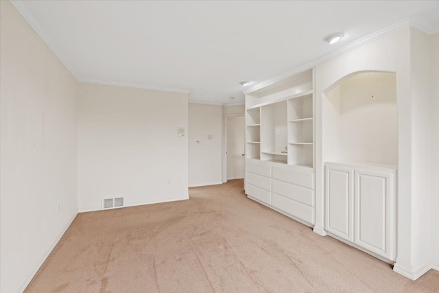 unfurnished room featuring light carpet and ornamental molding