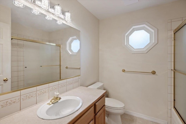 bathroom featuring tile patterned flooring, vanity, and toilet