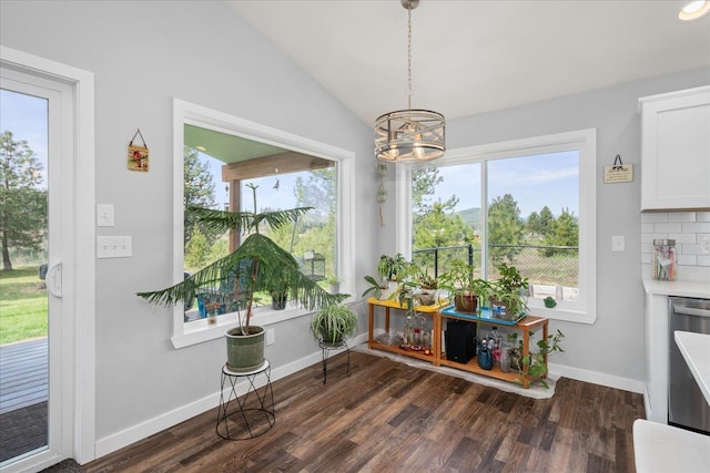 dining area featuring a notable chandelier, baseboards, vaulted ceiling, and dark wood finished floors