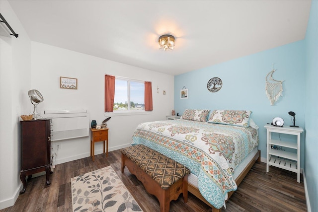 bedroom featuring wood finished floors and baseboards