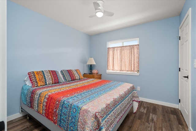 bedroom featuring a ceiling fan, baseboards, and wood finished floors