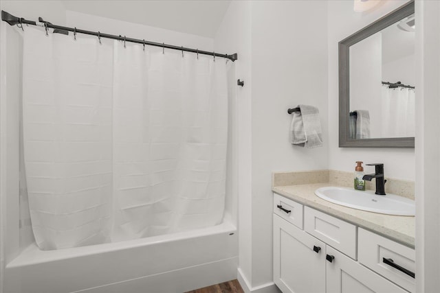 full bath featuring shower / tub combo, wood finished floors, and vanity