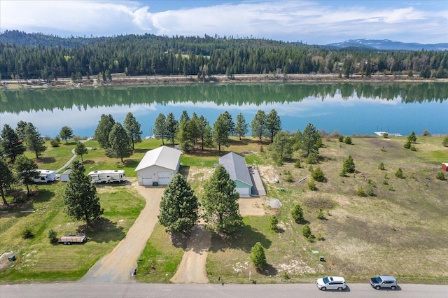 drone / aerial view featuring a water view and a wooded view