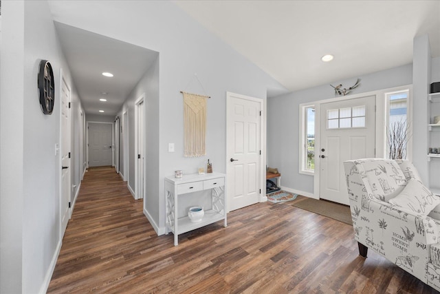 foyer featuring dark wood-style floors, recessed lighting, lofted ceiling, and baseboards