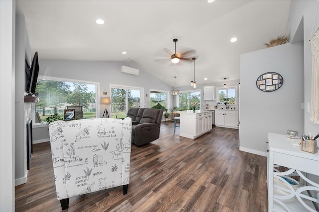 living room with lofted ceiling, an AC wall unit, dark wood-type flooring, and baseboards