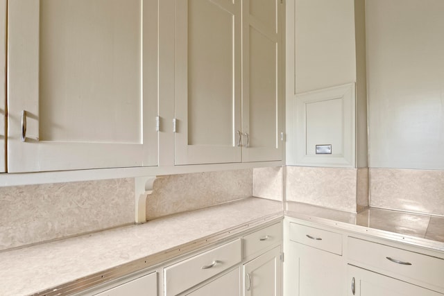 kitchen with decorative backsplash and white cabinets