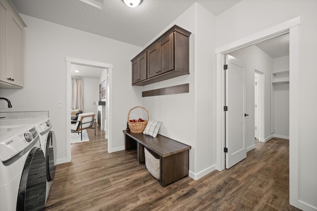 kitchen with dark wood-type flooring, dark brown cabinets, washer and clothes dryer, and a textured ceiling