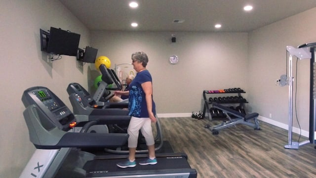 workout area with hardwood / wood-style floors