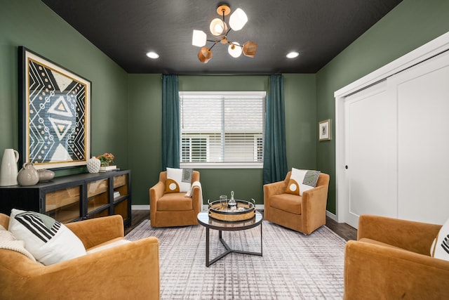 sitting room with light hardwood / wood-style floors, an inviting chandelier, and a textured ceiling