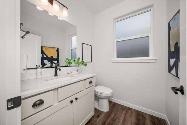 bathroom with vanity, toilet, and wood-type flooring