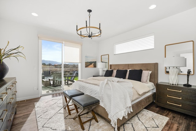 bedroom featuring access to exterior, multiple windows, and dark wood-type flooring