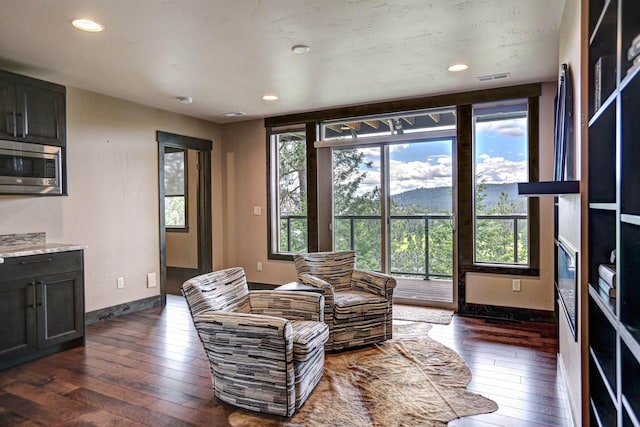 living area featuring a mountain view, recessed lighting, dark wood-type flooring, visible vents, and baseboards