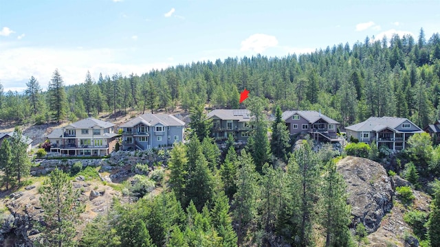 drone / aerial view with a residential view and a view of trees