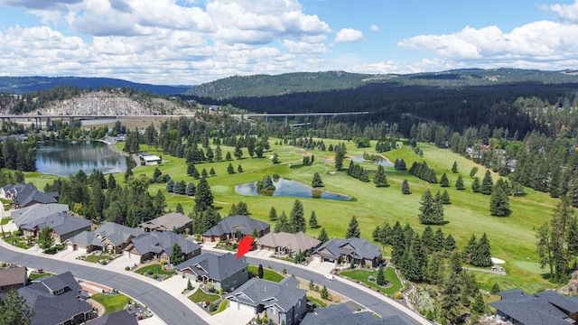 birds eye view of property featuring a residential view, a view of trees, golf course view, and a water and mountain view