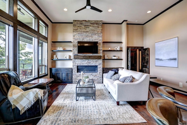 living room with ornamental molding, a fireplace, and dark wood finished floors