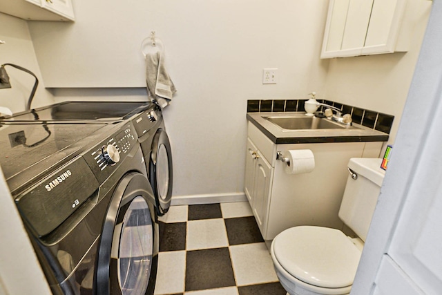 1619 W 8th Ave, Spokane, WA 99204 - laundry room featuring washer and clothes dryer, tile patterned floors, and baseboards