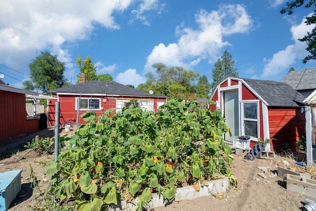 exterior space featuring an outbuilding, a chimney, and a storage shed