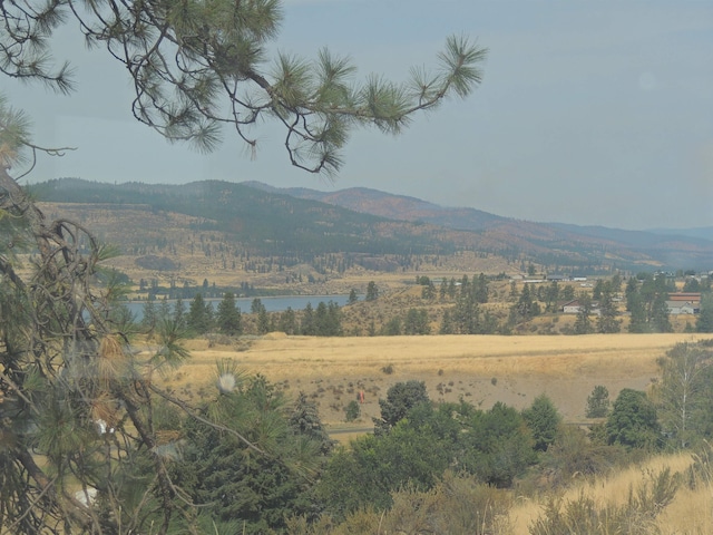 view of mountain feature featuring a water view and a rural view