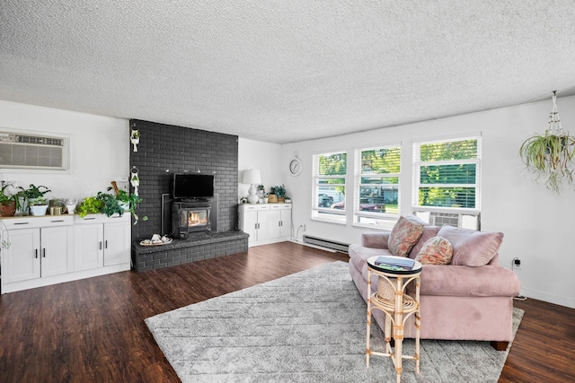 living room with a textured ceiling, a wall mounted AC, a fireplace, hardwood / wood-style floors, and baseboard heating