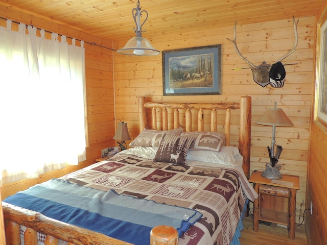 bedroom with hardwood / wood-style floors, wooden ceiling, and wooden walls