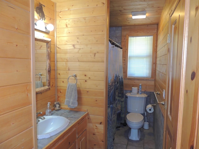 bathroom with vanity, wood walls, toilet, and wooden ceiling