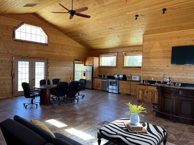 living room featuring high vaulted ceiling, french doors, wooden walls, ceiling fan, and wood ceiling