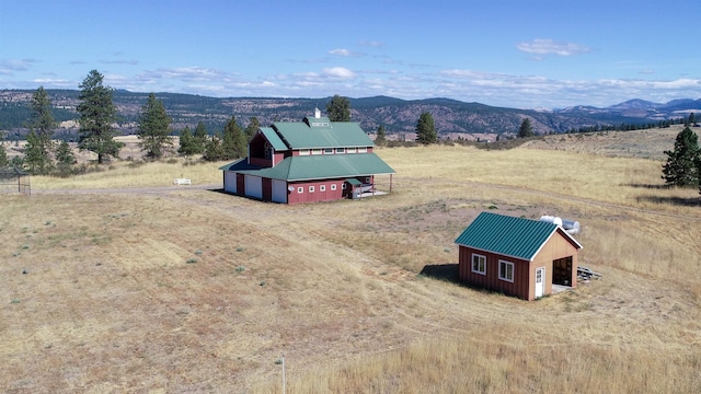 drone / aerial view featuring a mountain view and a rural view