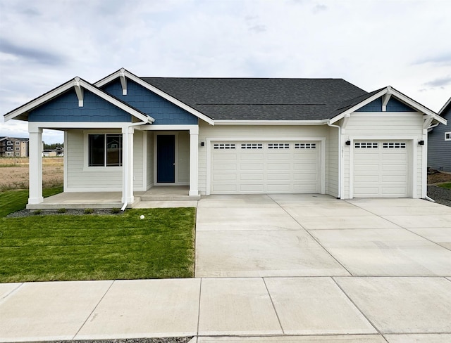 5871 S Sherri Lea Rd, Spokane, WA 99224 - view of front facade featuring driveway, an attached garage, a front yard, and a shingled roof