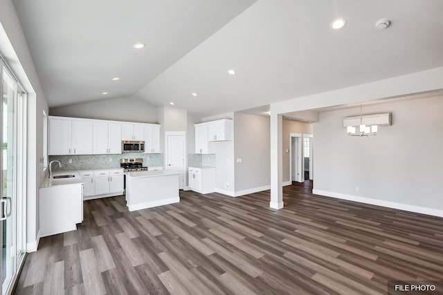 5871 S Sherri Lea Rd, Spokane, WA 99224 - kitchen with tasteful backsplash, a center island, lofted ceiling, stainless steel appliances, and a sink