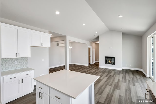 5871 S Sherri Lea Rd, Spokane, WA 99224 - kitchen with lofted ceiling, light countertops, a glass covered fireplace, open floor plan, and backsplash