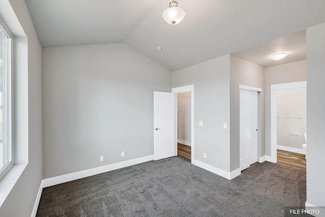 5871 S Sherri Lea Rd, Spokane, WA 99224 - unfurnished bedroom featuring lofted ceiling, baseboards, dark colored carpet, and a closet