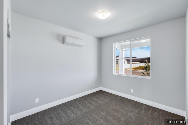 5871 S Sherri Lea Rd, Spokane, WA 99224 - unfurnished room with baseboards, an AC wall unit, and dark carpet